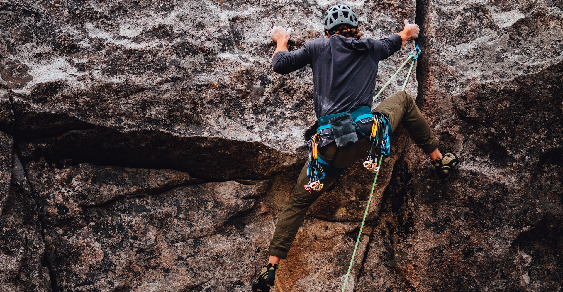 climbing one of the mnay rock faces in the peak district